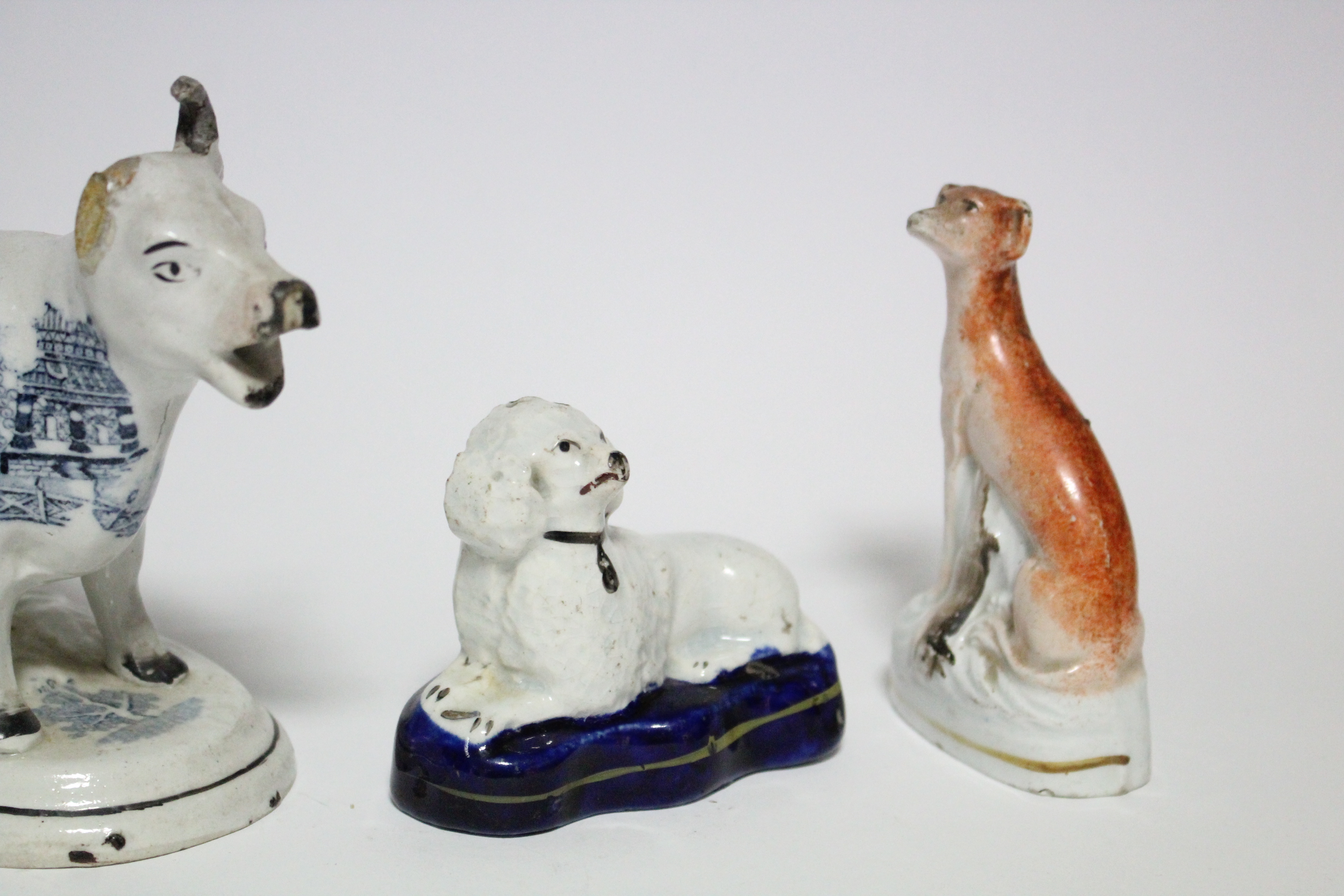 Three small Victorian Staffordshire pottery models of seated dogs, the largest 4” high; a ditto - Image 4 of 5