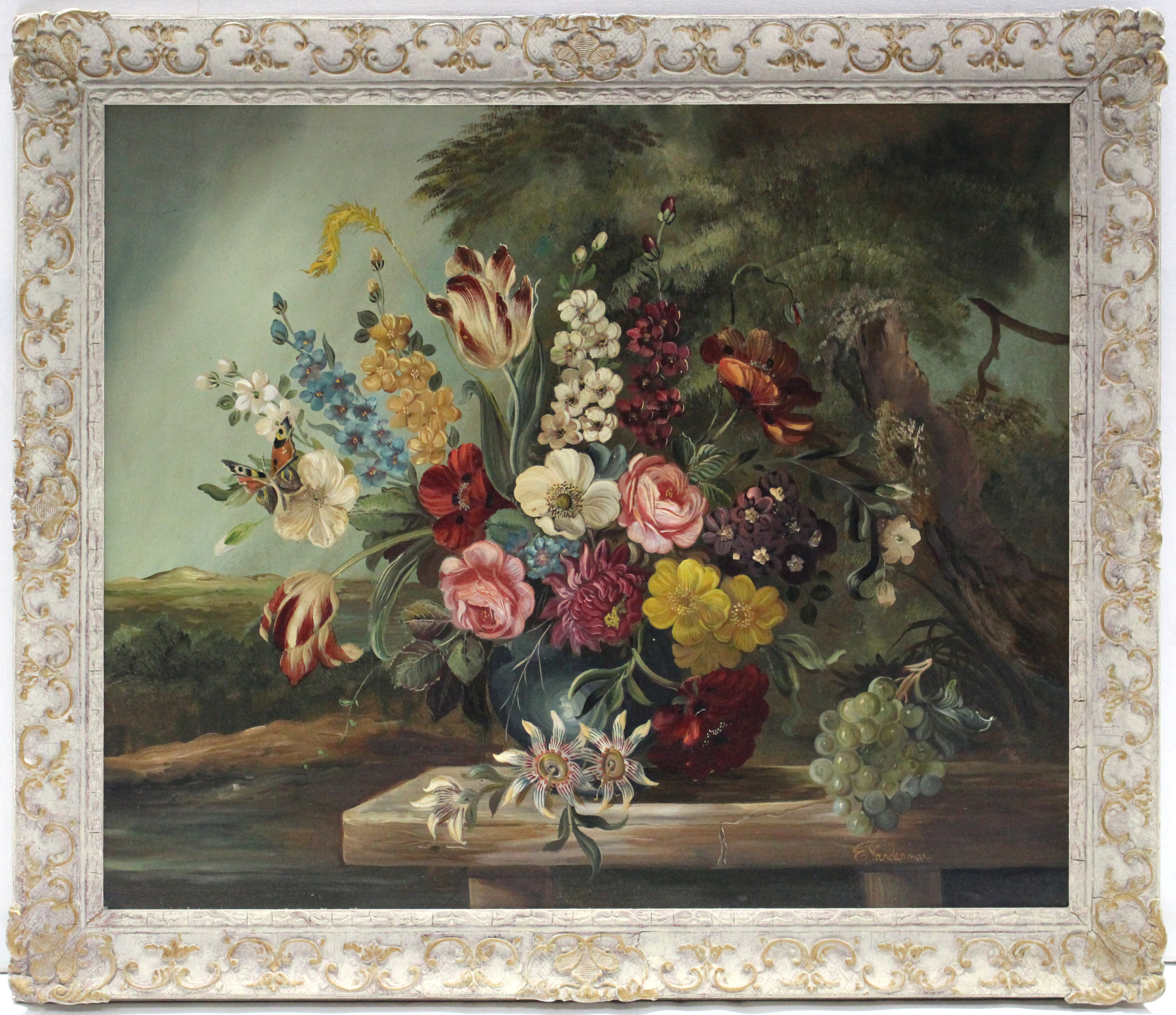 E. VAN DERMAN (19th/20th century) A still life study of a vase of flowers in a landscape. Signed;