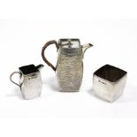 A late Victorian silver small three-piece coffee service of slightly bowed rectangular form & with