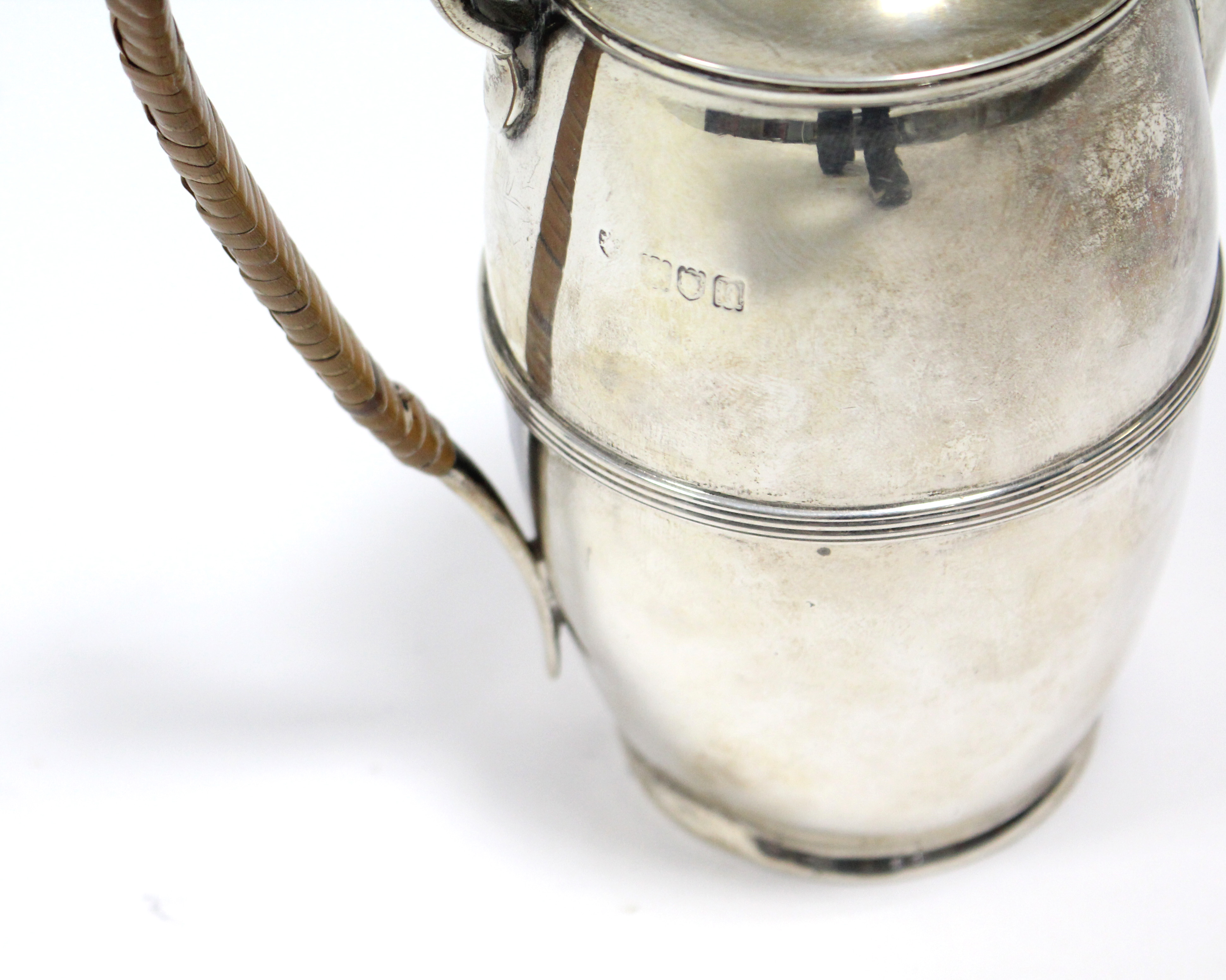 An Edwardian silver hot water jug of slender ovoid shape with reeded band around the girth, cane- - Image 3 of 4