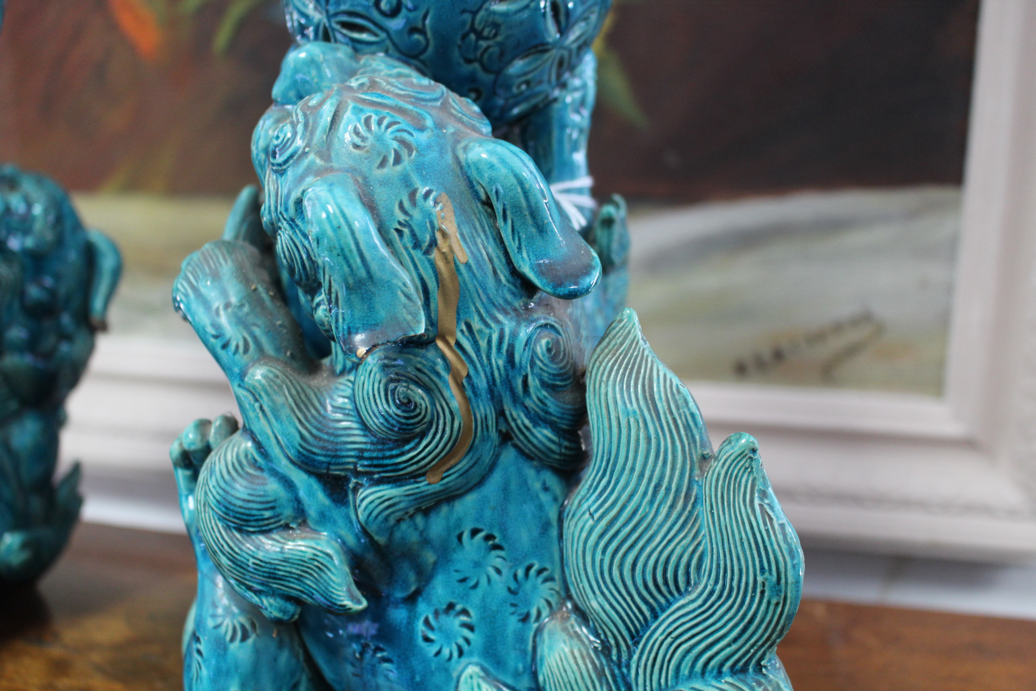 A pair of 19th century Chinese turquoise-glazed groups, each of two Kylin fighting over a brocaded - Image 6 of 9