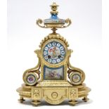 A 19th century French mantel clock, the painted porcelain dial with roman numerals, in gilt case