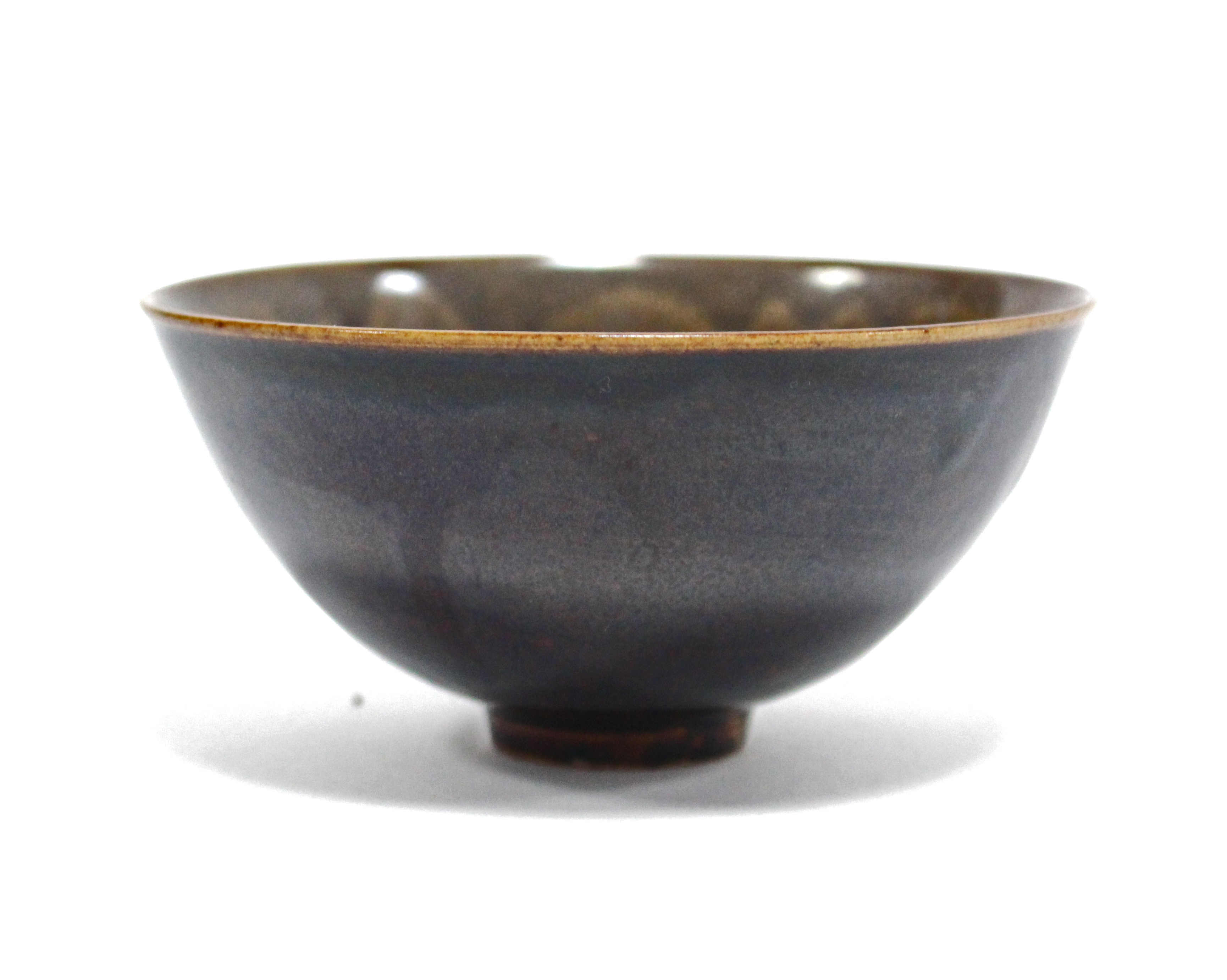 A finely potted Chinese small deep bowl with teadust-glazed interior, the exterior with rich brown