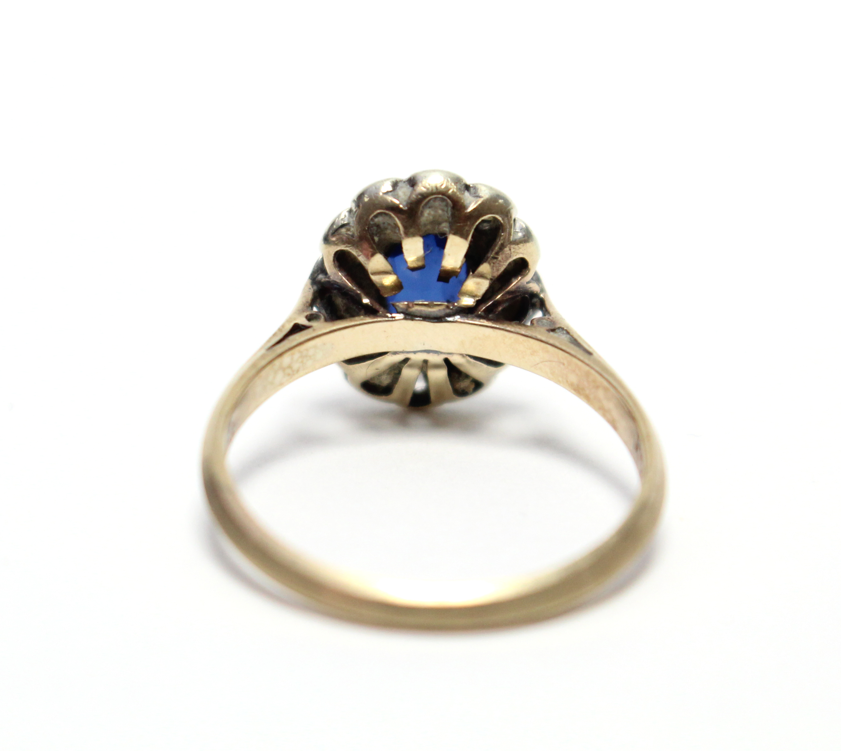 A 9ct. gold ring set oval synthetic sapphire within a border of small diamonds. - Image 5 of 5