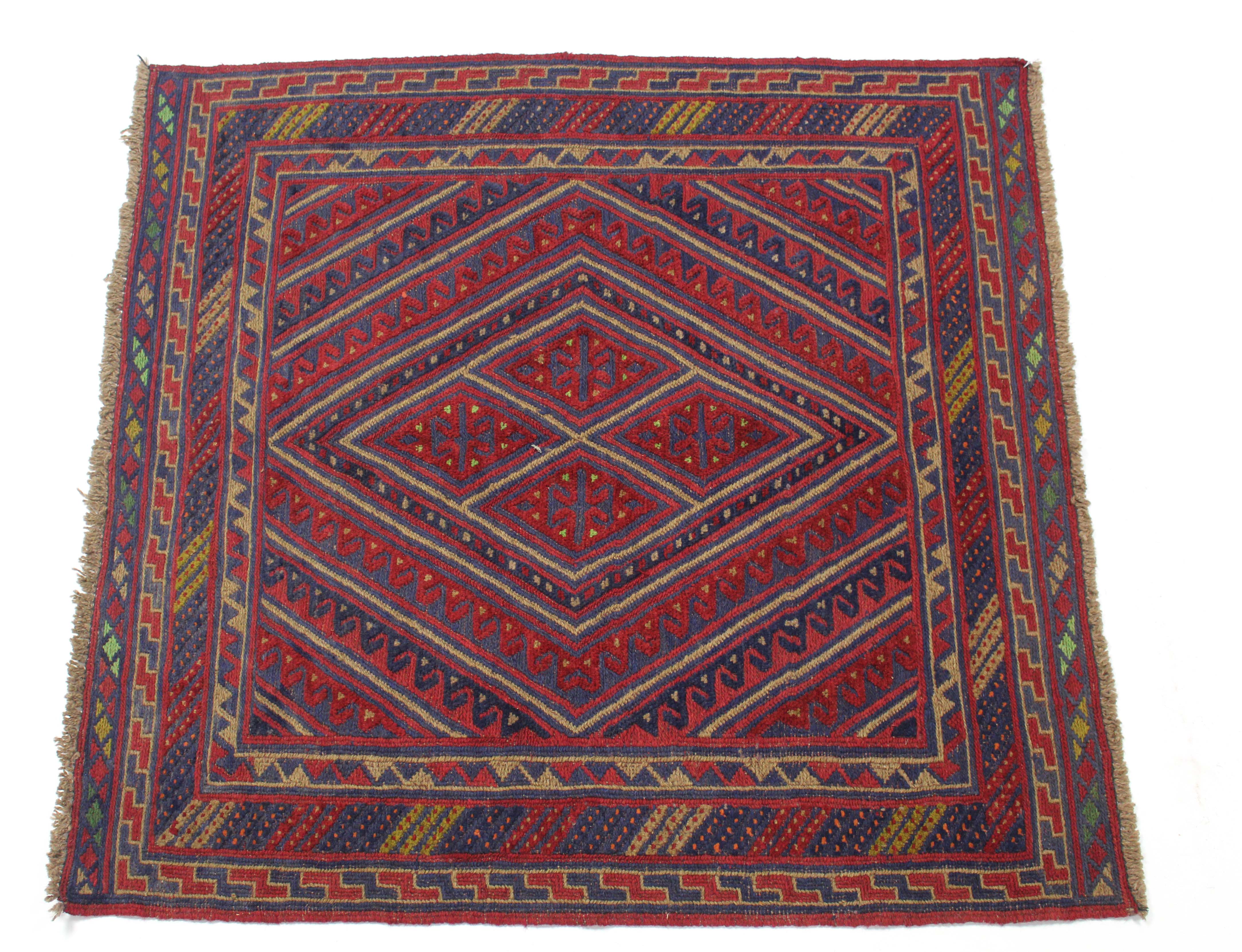 A Kazak rug of crimson & blue ground with central lozenge & hook design within multiple geometric