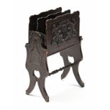 A Victorian carved oak two-division magazine rack by JACQUET, with applied foliate crest to each