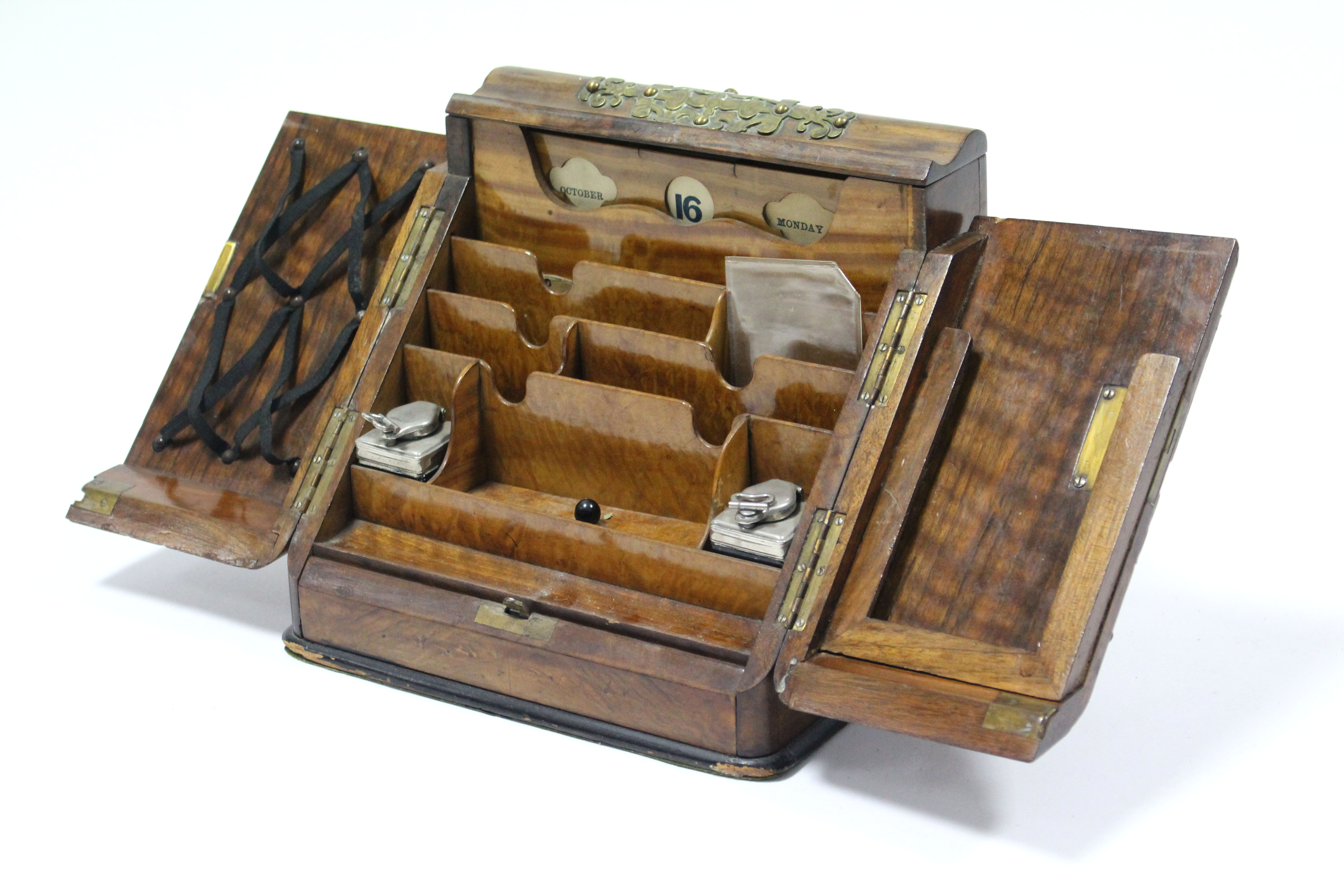 A Victorian burr-walnut stationery cabinet with engraved brass strap-work mounts, the sloping