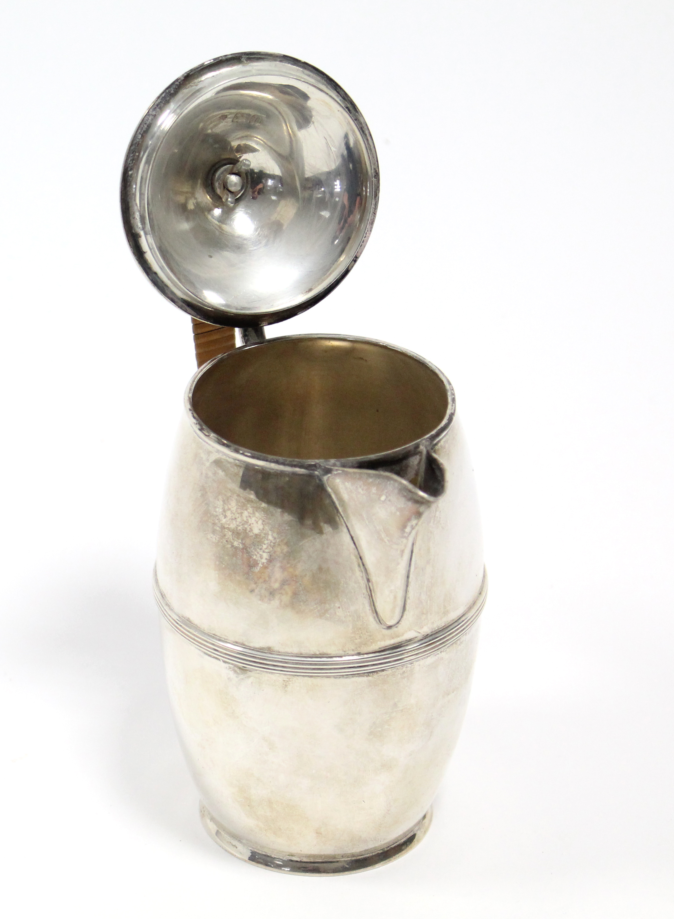 An Edwardian silver hot water jug of slender ovoid shape with reeded band around the girth, cane- - Image 2 of 4