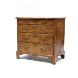 A GEORGE I BURR-WALNUT CHEST, the quarter-veneered top with herringbone crossbanding & moulded edge,