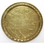 A 17th century style brass dish with stylised embossed & pricked decoration of a mermaid with comb &