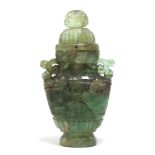 A Chinese carved quartz vase & cover of semi-opaque green colour with russet patches, of flat-