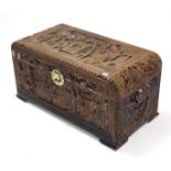 A Chinese carved camphor wood trunk with figure-scene decoration to the hinged lift lid & sides, &