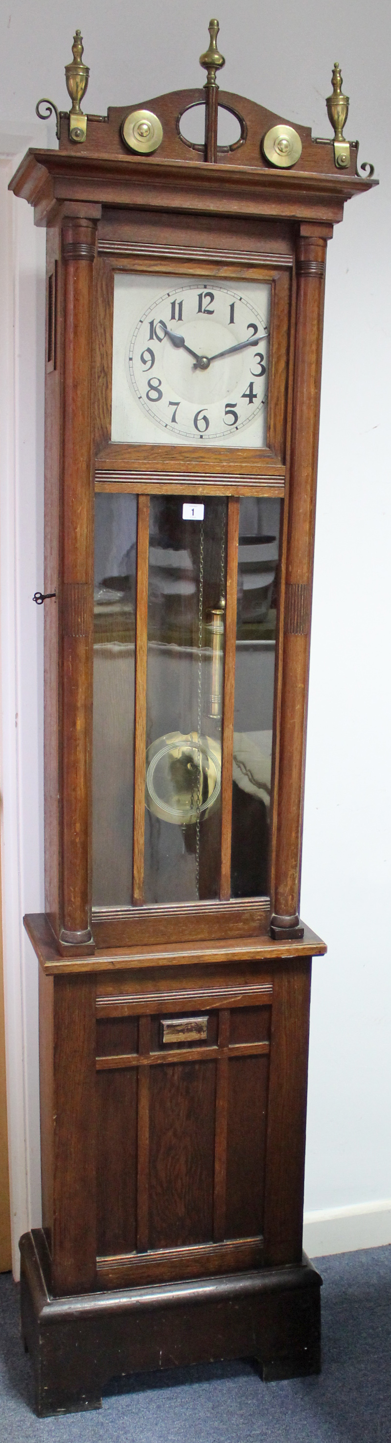 A mid-20th century grandfather clock with silvered dial, & in oak case enclosed by glazed door,