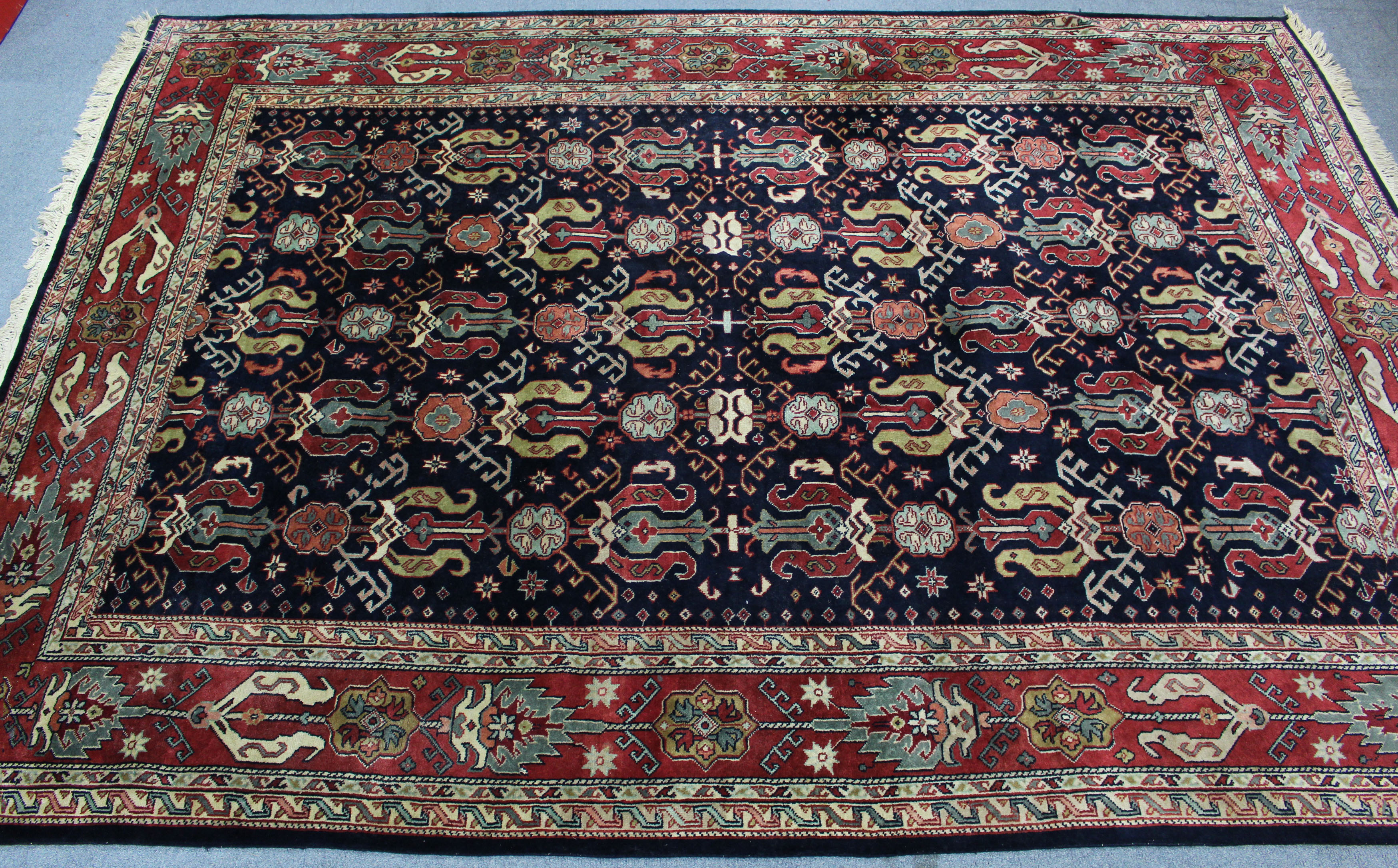 A Persian pattern carpet of crimson & ivory ground, with all-over repeating multi-coloured geometric - Image 2 of 4