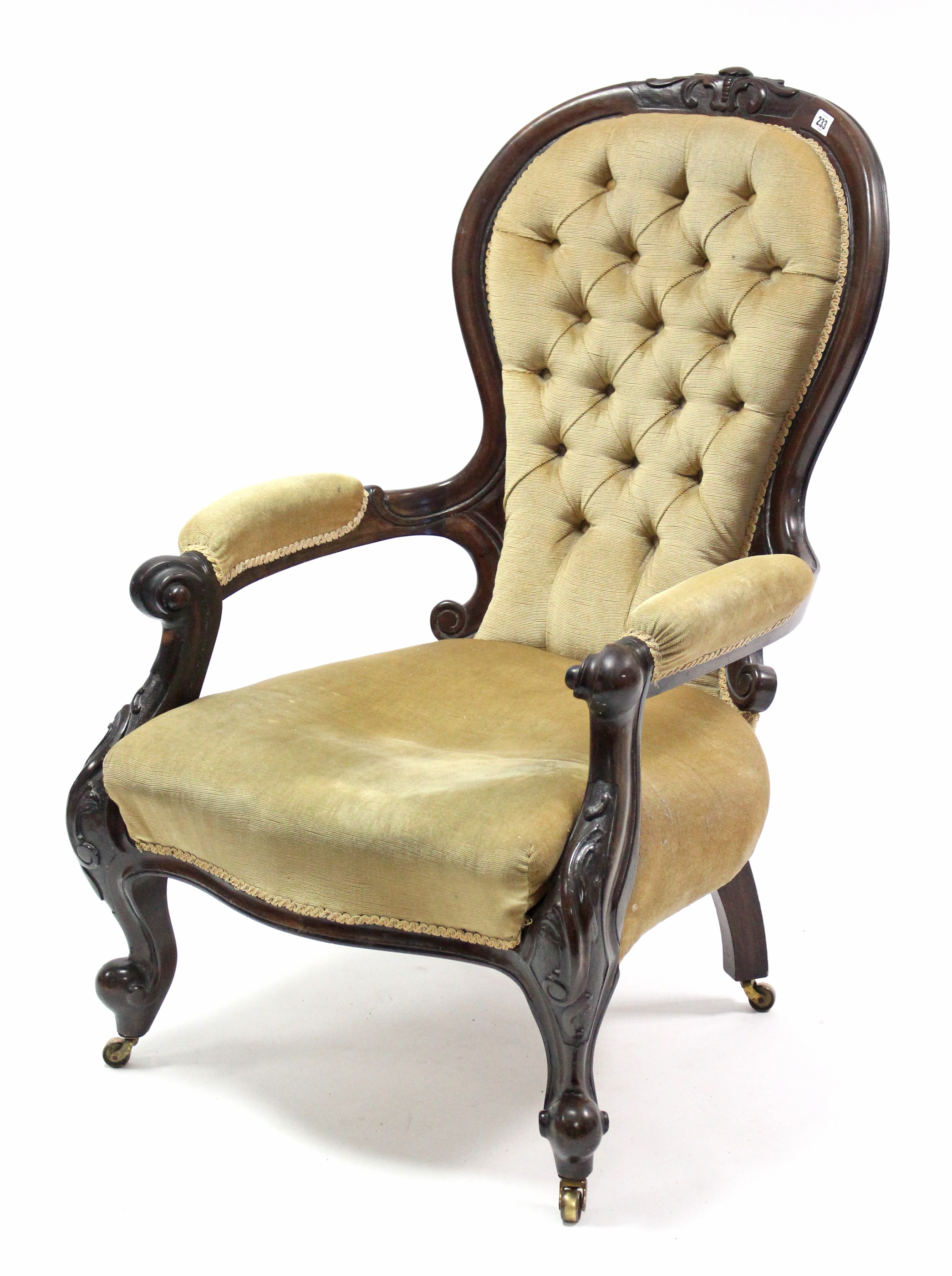 A mid Victorian carved walnut-frame buttoned-back armchair upholstered old gold velour, with open