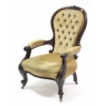 A mid Victorian carved walnut-frame buttoned-back armchair upholstered old gold velour, with open