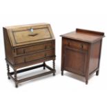A 1930’s small oak bureau with fitted interior enclosed by fall-front above two long graduated