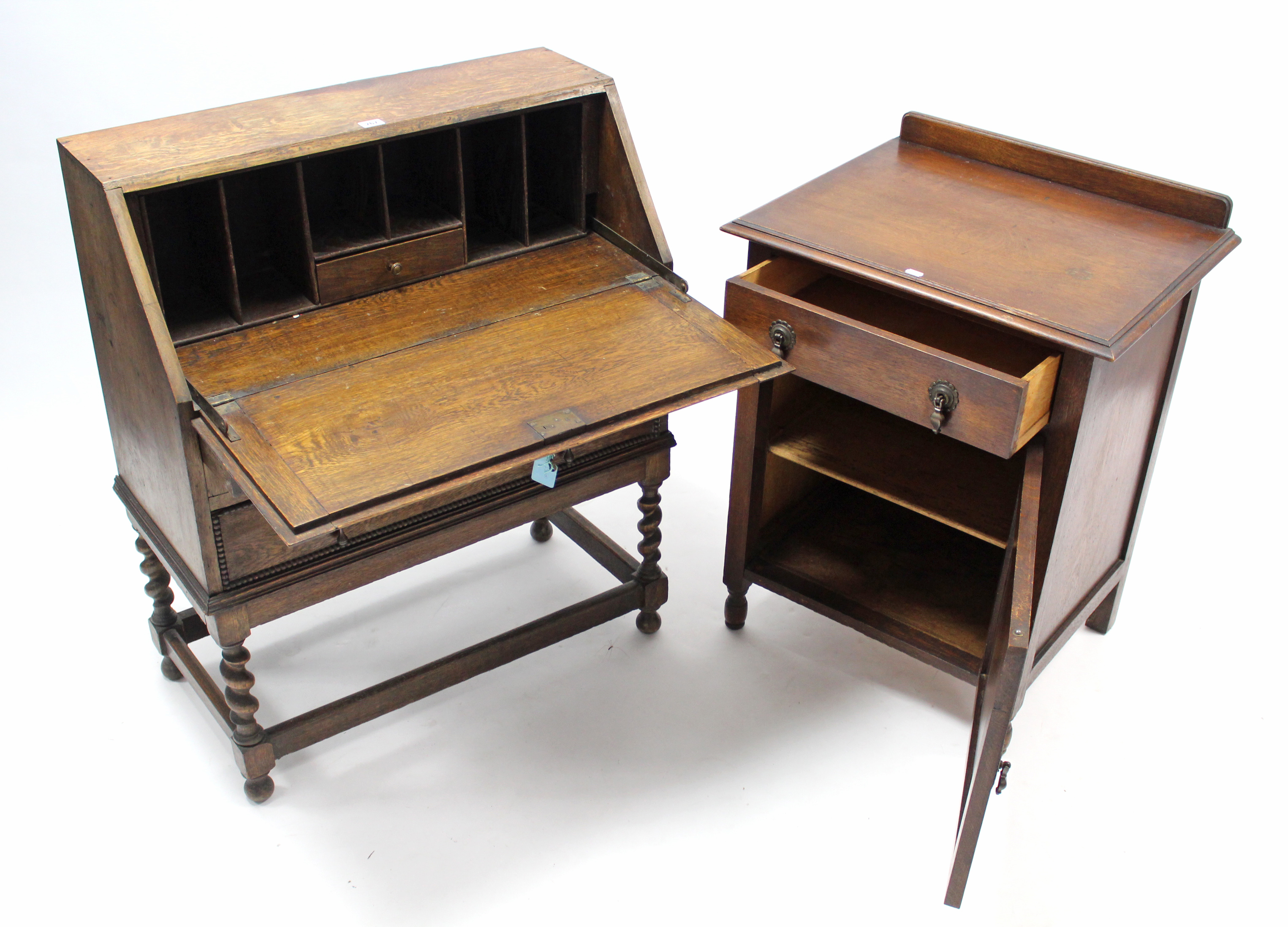 A 1930’s small oak bureau with fitted interior enclosed by fall-front above two long graduated - Image 2 of 2