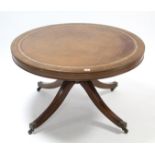 A reproduction mahogany low coffee table, inset gilt-tooled brown leather to the circular top, &