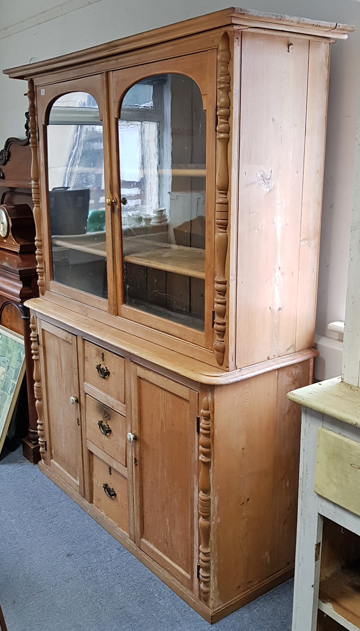 A VICTORIAN-STYLE PINE DRESSER, the upper part fitted two shelves enclosed by pair of glazed