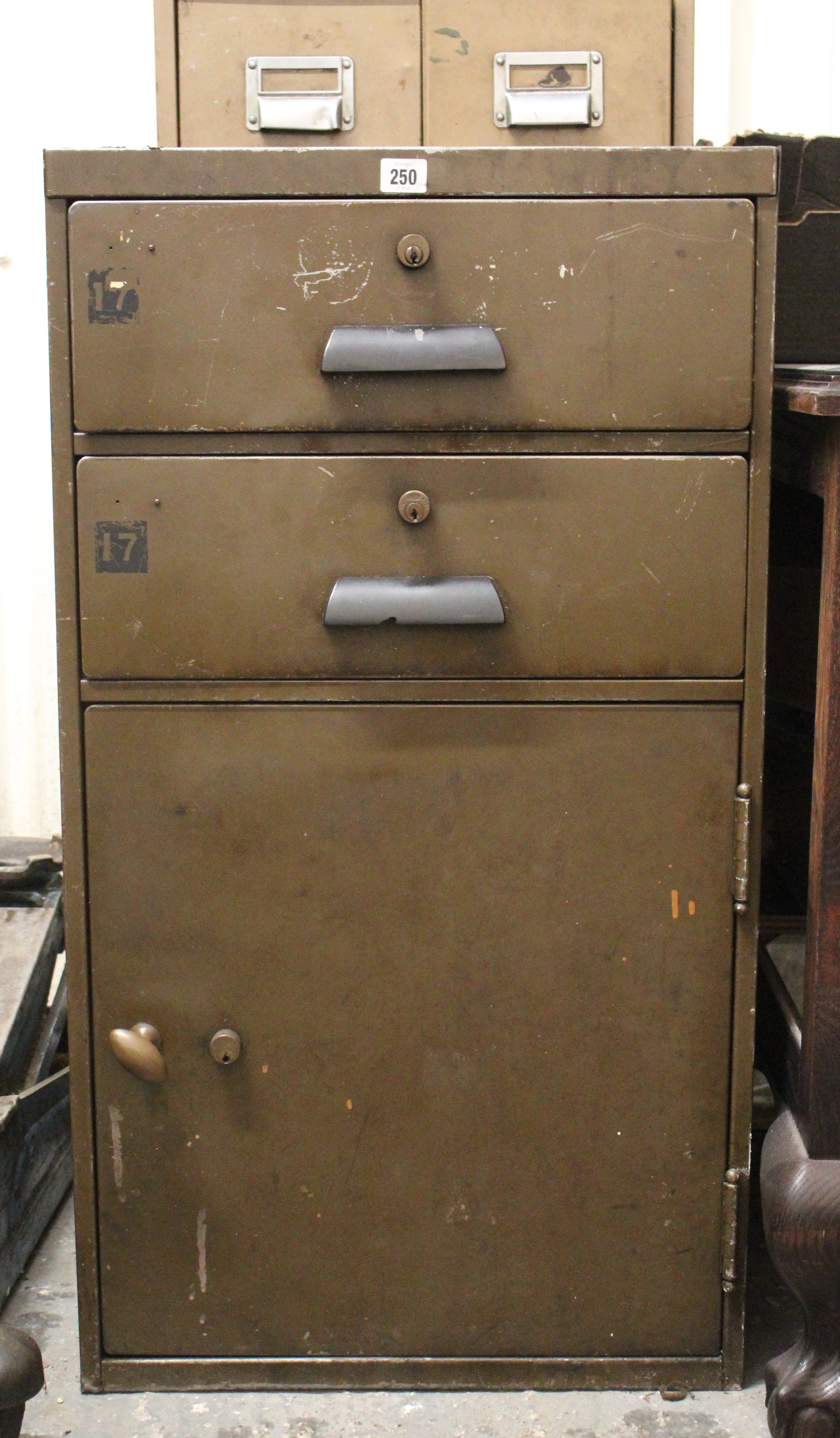 A dark brown art-metal dwarf standing cabinet, fitted two long drawers above two long shallow