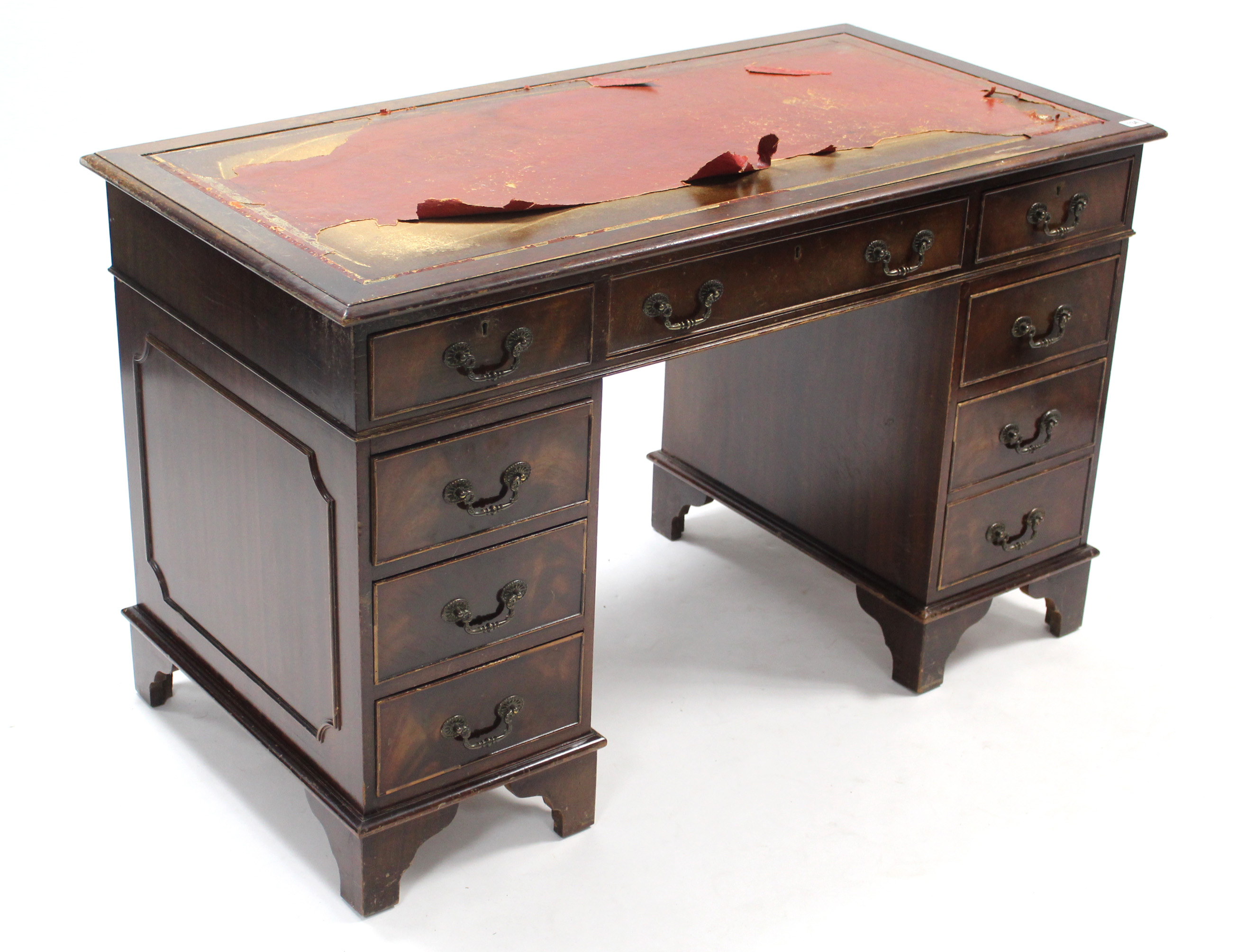 A reproduction mahogany pedestal, desk fitted with an arrangement of eight drawers, & on bracket