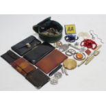 A gilt-metal compact; an “AA” car membership badge; five pocket knives; six purses; & various