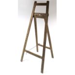 A large wooden fold-away easel, 85” high.