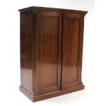 An Edwardian mahogany small upright cabinet fitted three shelves enclosed by pair of panel