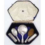 A George V silver-backed five-piece dressing table set, Birmingham 1916, cased.