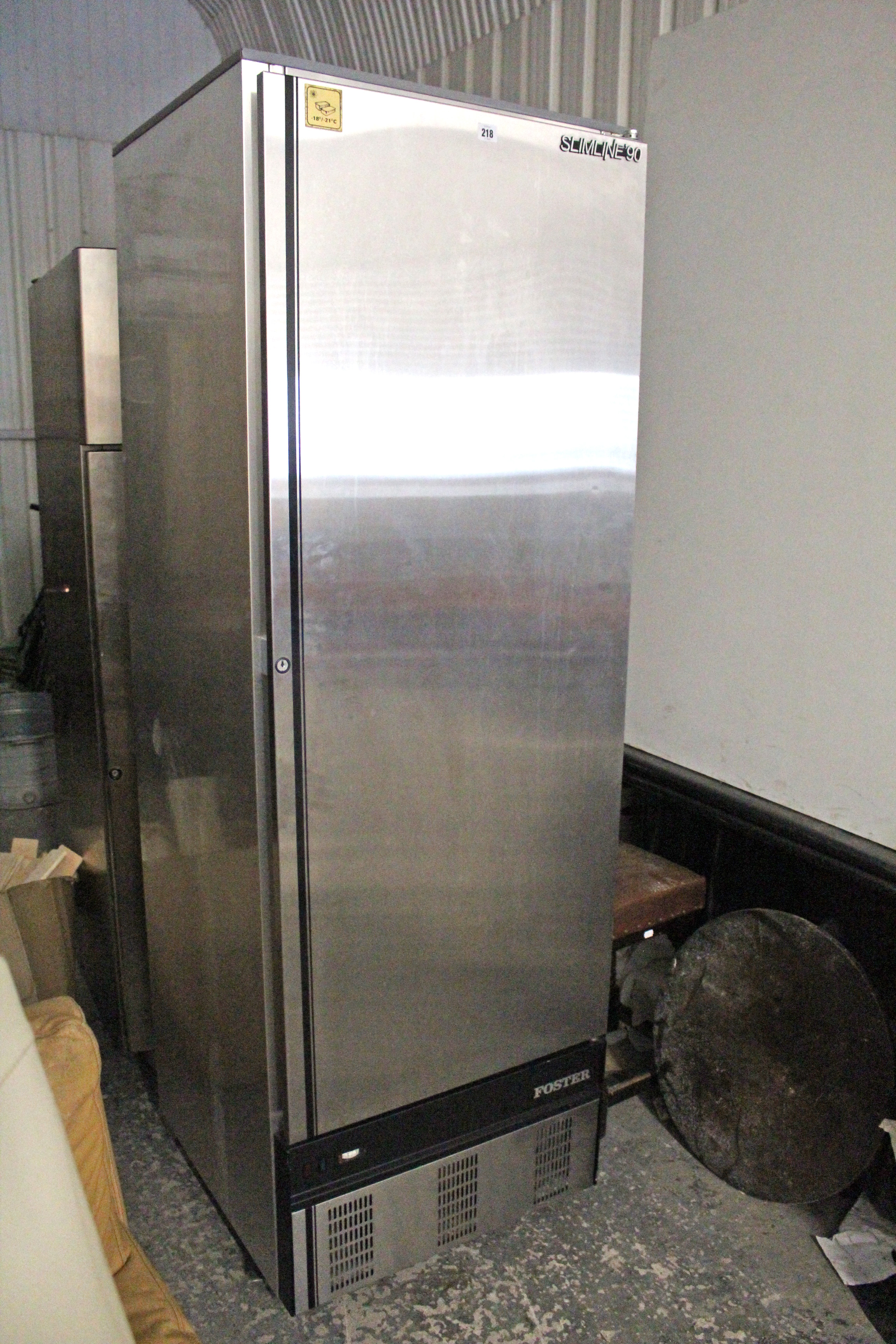 A Foster “Slimline 90” tall catering grade chiller cabinet refrigerator in silvered finish case,