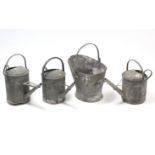 Three galvanised-metal oval watering cans; & a ditto coal scuttle