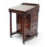 A Victorian rosewood davenport, inset tooled brown leather to the sloping hinged-top, fitted four