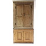 A light oak & pine tall standing corner cupboard enclosed by two pairs of panel doors, 36½” wide x