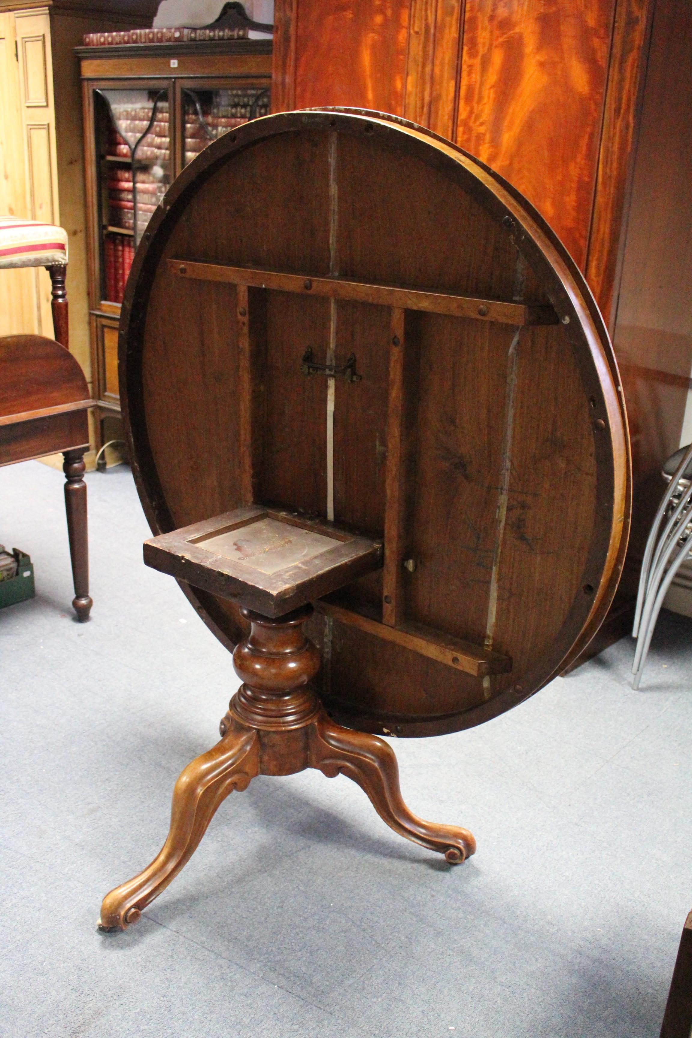 A Victorian mahogany loo table with circular tilt-top; & on vase turned centre column & three carved - Image 3 of 3