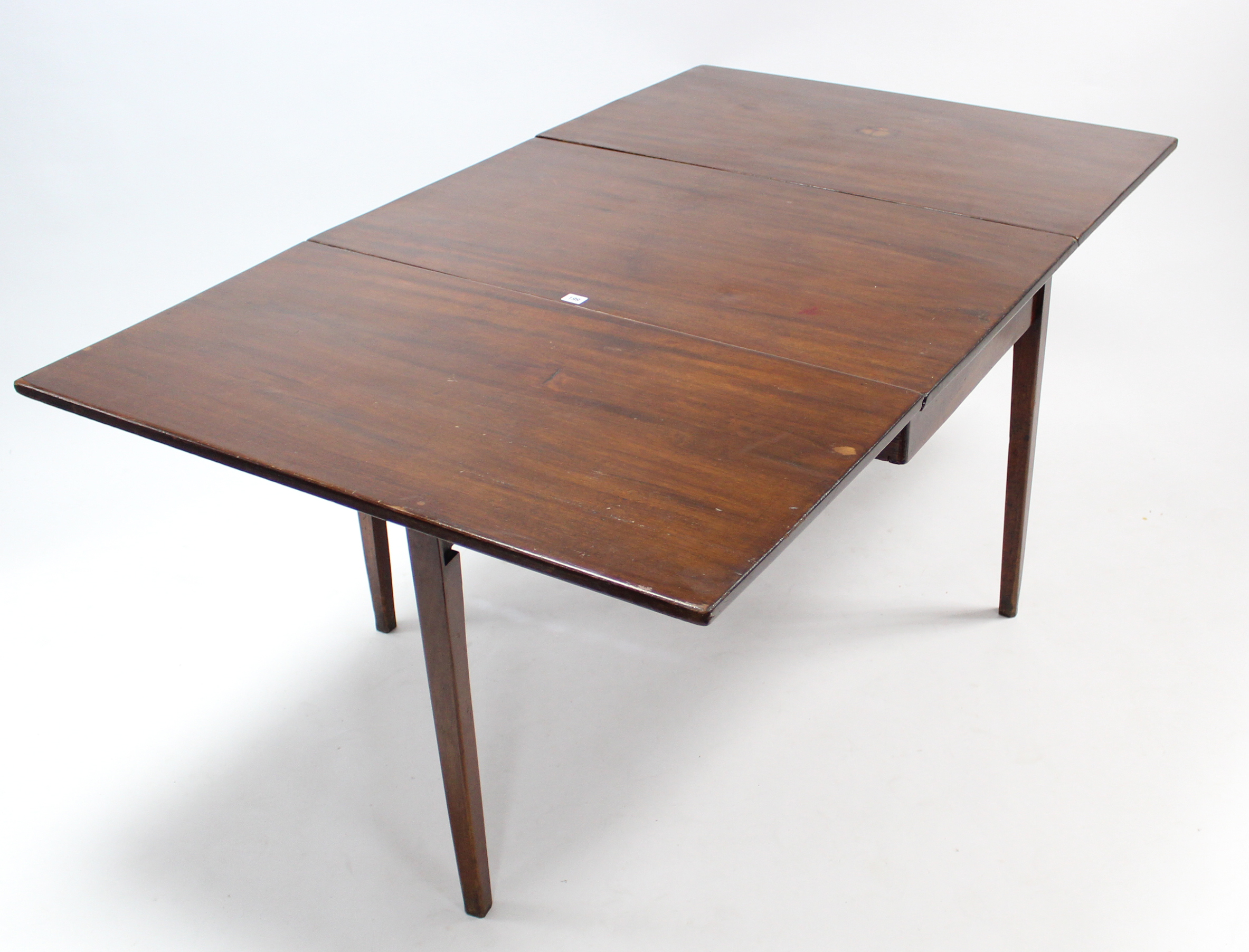 A 19th century mahogany drop-leaf dining table on square tapered legs, 40¼” x 65¾”.