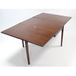 A 19th century mahogany drop-leaf dining table on square tapered legs, 40¼” x 65¾”.