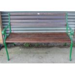 A teak slatted garden bench with green painted cast-iron end supports, 49½” long.