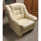 A cream leatherette armchair.