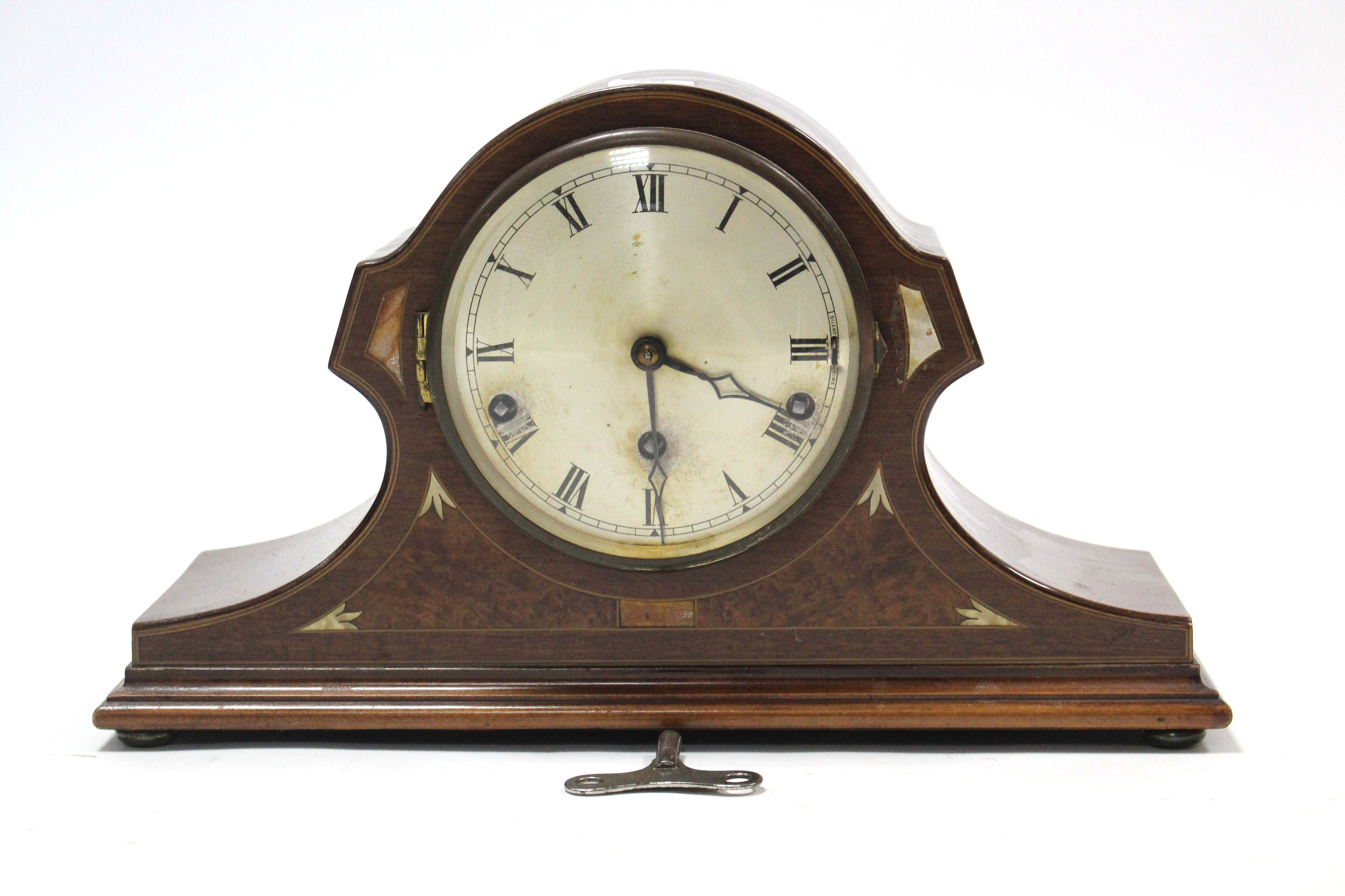 An Edwardian mantel clock with silvered dial, chiming movement, & in inlaid-mahogany case, 9½” high;