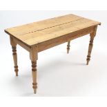 A pine kitchen table with rounded corners to the rectangular top, & on turned tapered legs, 51½” x