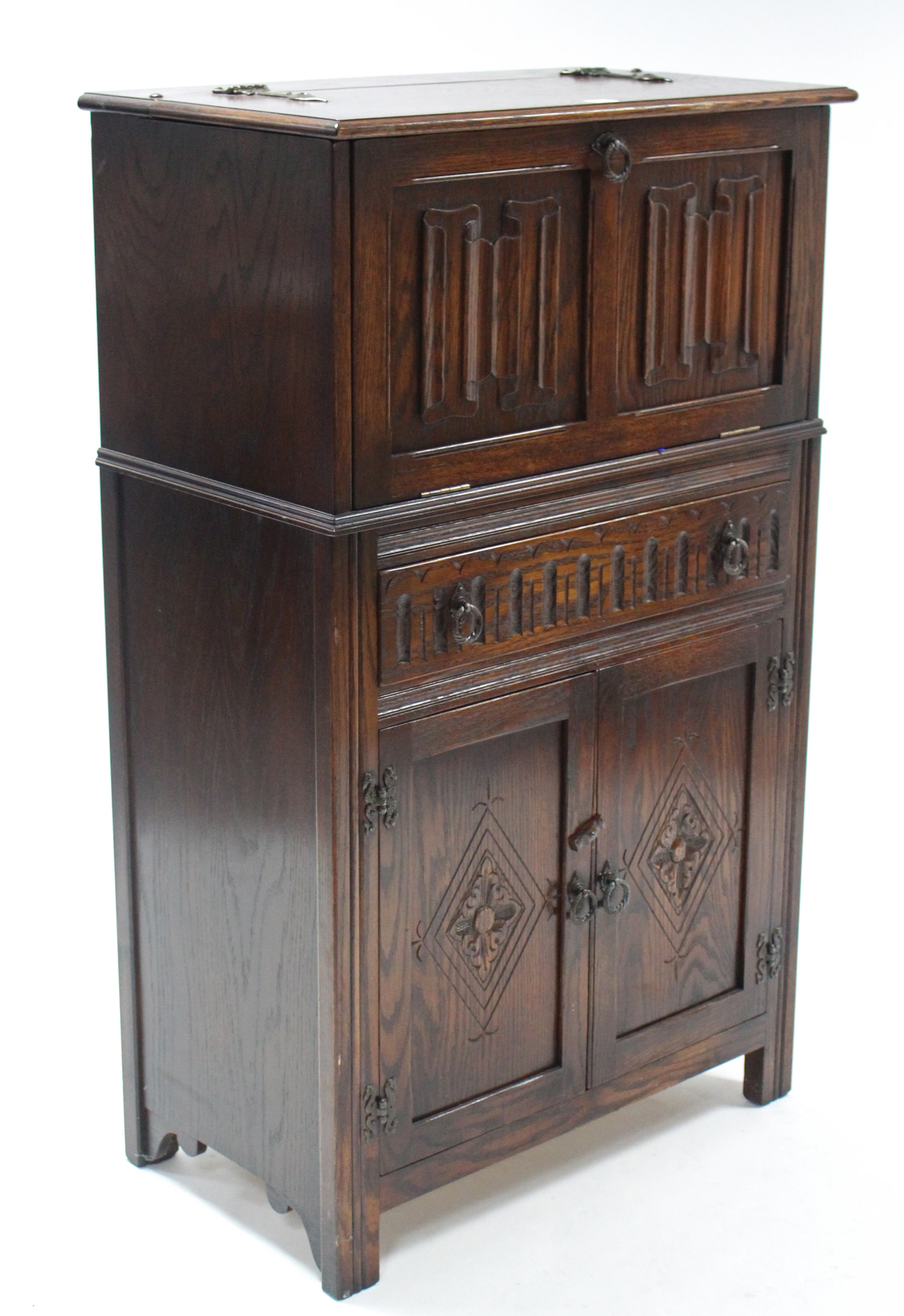 A Jaycee oak cocktail cabinet, enclosed by hinged lift-lid & linen-fold panel door & fitted long