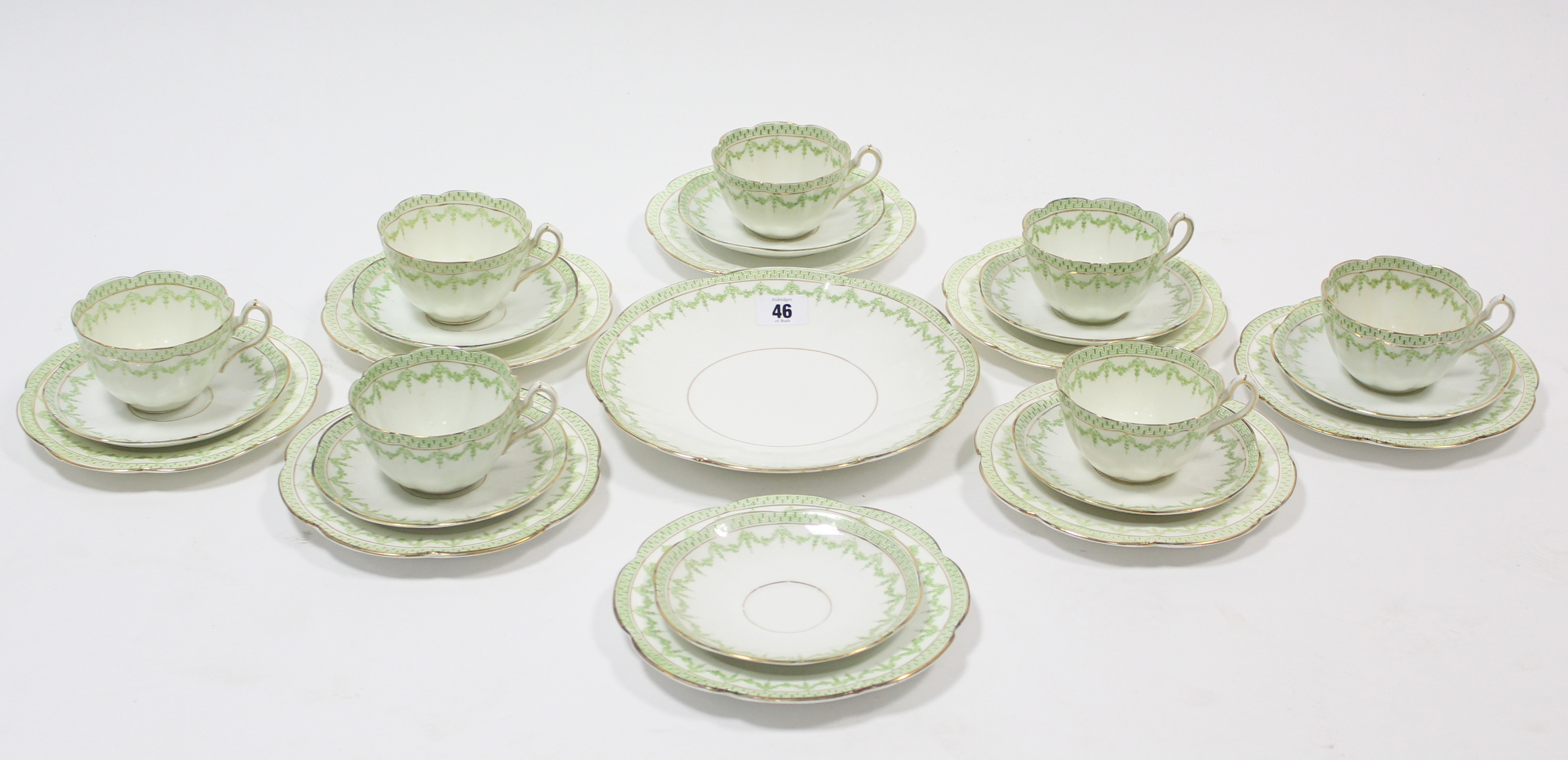 A Court china twenty-four piece part tea service of white ground & with green foliate design.