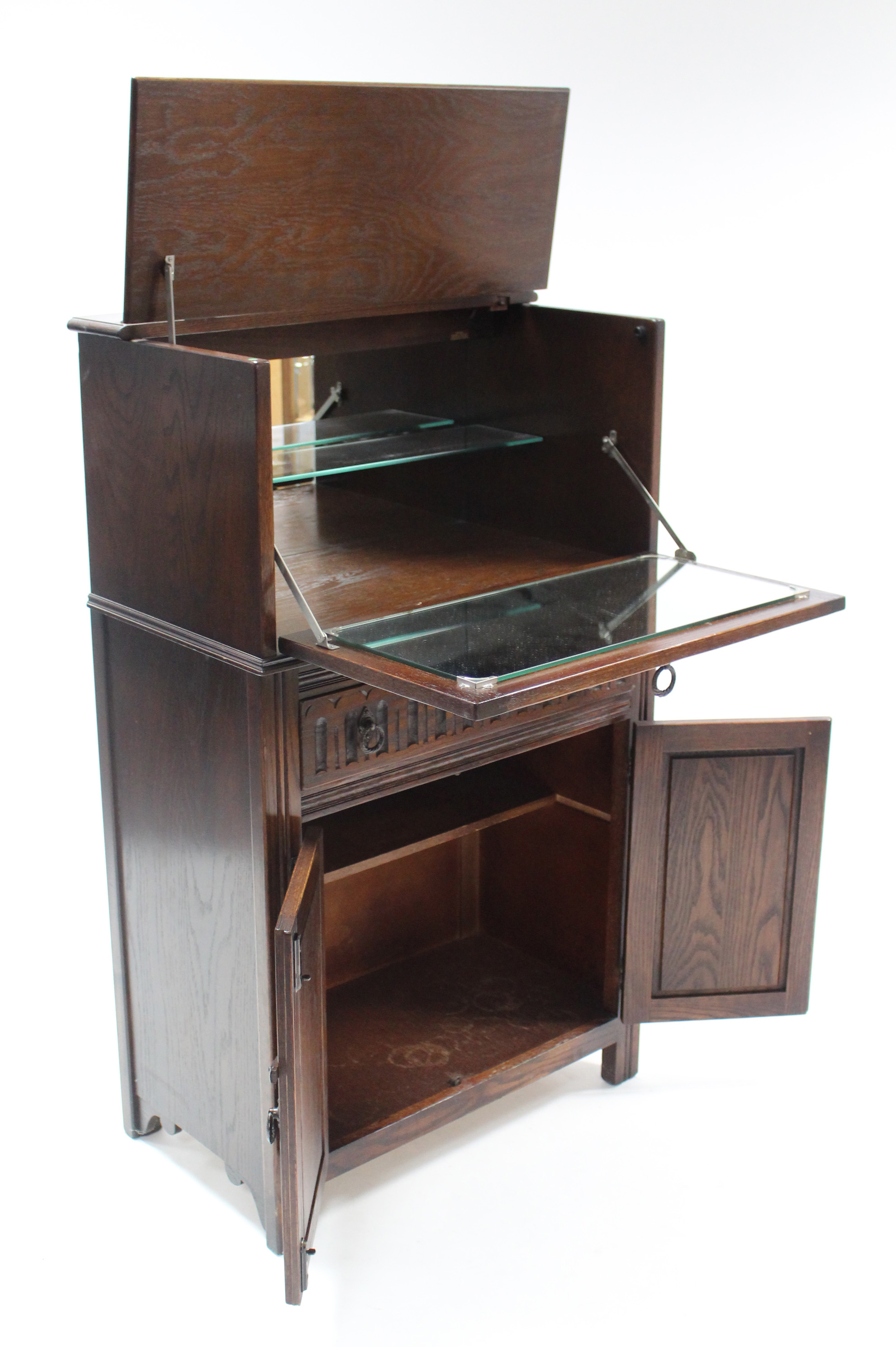 A Jaycee oak cocktail cabinet, enclosed by hinged lift-lid & linen-fold panel door & fitted long - Image 2 of 2