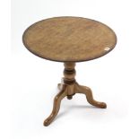 A 19th century mahogany tripod table with circular tilt-top & on vase-turned centre column & three