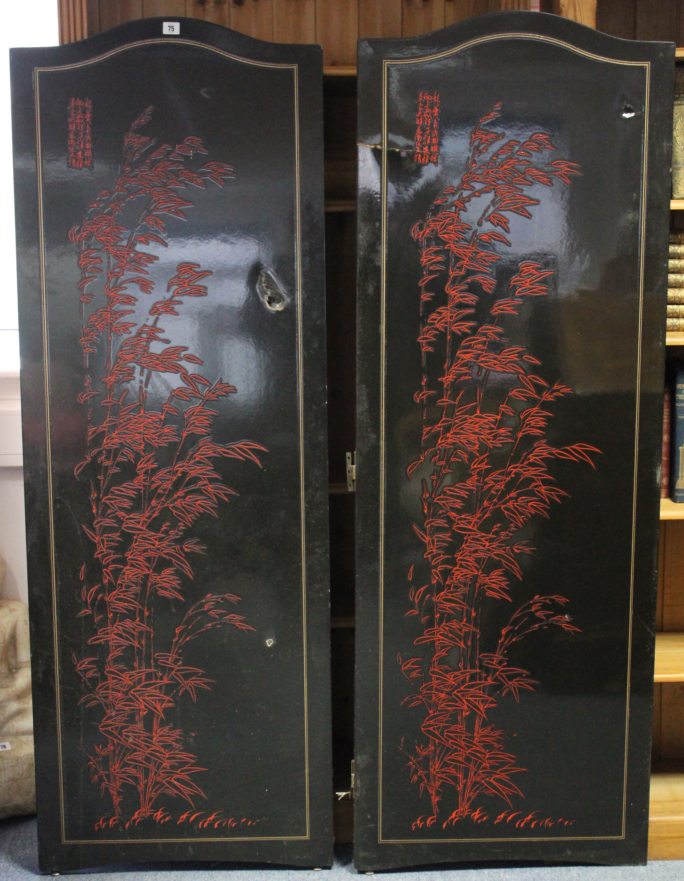 An oriental black & red lacquered four-fold draught screen, 66½” high w.a.f.; & a cloth-covered