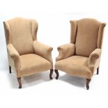 A pair of wing-back armchairs upholstered fawn velour, & on short cabriole legs.