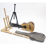 A six-string acoustic guitar with case; & two artists’ easels.