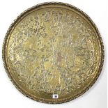 A late 19th/early 20th century Burmese brass circular tray with embossed figure & animal decoration,