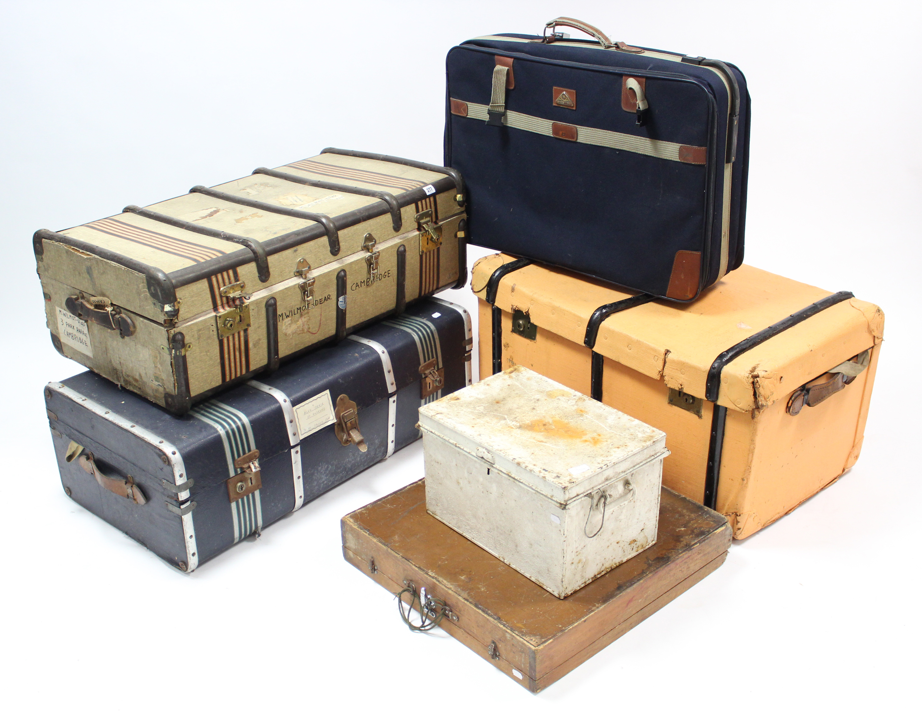 Three fibre-covered travelling trunks; together with two other trunks; & a suitcase